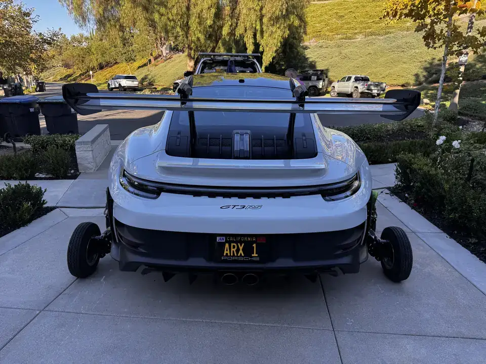 White Porsche 911 GT3 RS lifted on wheel dollies for a damage-free tow