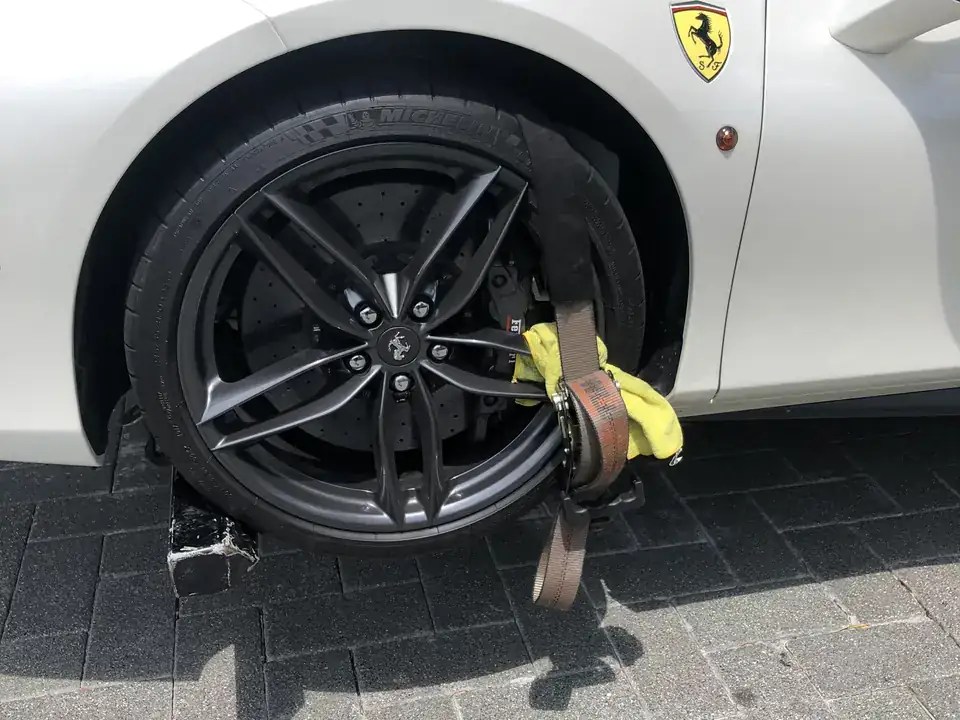 Ferrari 488 wheel secured with soft straps and padding for a no-scratch tow