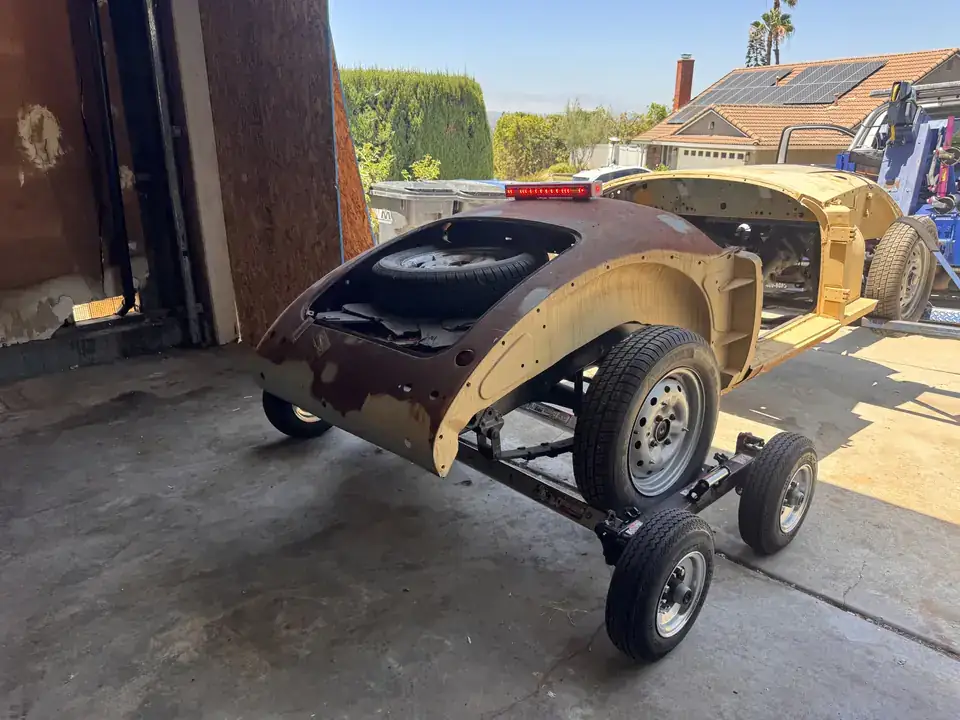 Classic Volkswagen Beetle body and chassis moved on a tow dolly